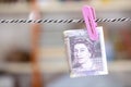 Pound banknotes clamped and hung Royalty Free Stock Photo