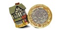 Pound gold coin toppling home property mortgage unstable house finance Royalty Free Stock Photo