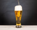 Pour beer in a glass with black background Royalty Free Stock Photo