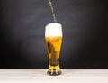 Pour beer in a glass with black background Royalty Free Stock Photo