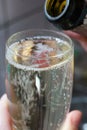 We pour champagne into a glass in the kitchen. Very close. Royalty Free Stock Photo