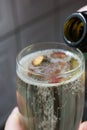 We pour champagne into a glass in the kitchen. Very close. Royalty Free Stock Photo