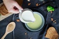 Pour cream into cream soup. Close-up. Milk jug with cream in female hands. Royalty Free Stock Photo