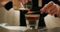 Pour espresso coffee into tonic water