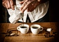 Pour espresso into cups - traditional Italian drink - selective focus - desaturated effect