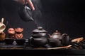 Pour hot water with a small Chinese teapot. Brewing green tea in China Royalty Free Stock Photo