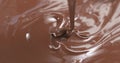 Pour milk chocolate from spoon Royalty Free Stock Photo