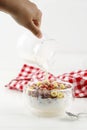 Pour Milk to the Bowl with Colorful Cereal RIng Royalty Free Stock Photo