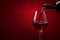 Pour red wine on red background. Generative ai Royalty Free Stock Photo