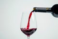 Pour red wine on white background. Generative ai Royalty Free Stock Photo