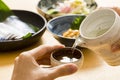 Pour sake at a table with side dishes Royalty Free Stock Photo