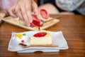 pour strawberry sauce to cheesecake, Sweet dessert Royalty Free Stock Photo