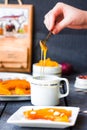 Pour a teaspoon honey in ceramic ware, baked pumpkin Royalty Free Stock Photo