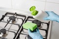 Pour washing detergent from bottle to green sponge