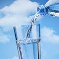 Pour water from the bottle into glass. Royalty Free Stock Photo