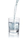 Pour water into the half-full glass with reflection isolated on Royalty Free Stock Photo