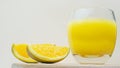 Pour yellow lemonade into a transparent glass with slices of oranges. Yellow juice, orange drink Royalty Free Stock Photo