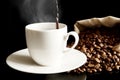 Poured coffee to cup with full bag isolated on black Royalty Free Stock Photo