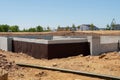 poured concrete foundation for new house construction in suburban neighborhood Royalty Free Stock Photo