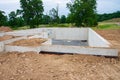 Poured concrete foundation for new house construction in suburban neighborhood Royalty Free Stock Photo