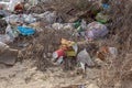 Poured garbage on Sea coast is left by tourists and vacationers. Dirty sea sandy shore of Sea. Environmental pollution.