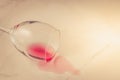 Poured wine glass on marble background/poured red wine glass on marble background. Top view and copyspace