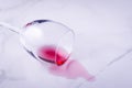 Poured wine glass on marble background/poured red wine glass on marble background