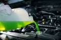 Pouring antifreeze coolant liquid into car engine radiator Royalty Free Stock Photo