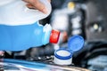 Pouring antifreeze. Filling a windshield washer tank with an antifreeze in winter cold weather. Royalty Free Stock Photo