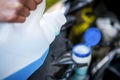 Pouring antifreeze. Filling a windshield washer tank with an antifreeze in winter cold weather. Royalty Free Stock Photo