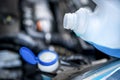 Pouring antifreeze. Filling a windshield washer tank with an antifreeze in winter cold weather. Royalty Free Stock Photo