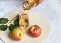 Pouring Apple juice into a glass Cup from a bottle.