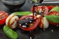 Pouring balsamic vinegar onto fresh vegetable salad on plate Royalty Free Stock Photo