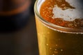 Pouring beer with bubble froth in glass for background Royalty Free Stock Photo