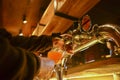 Pouring beer. Cropped image of bartender poring beer into the beer glass.