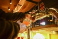 Pouring beer. Cropped image of bartender poring beer into the beer glass.