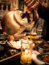 Pouring Beer into a Glass from a Kettle in a cozy Japanese bar