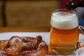 pouring beer into a large glass mug on plate with warm soft pretzel appetizer Royalty Free Stock Photo