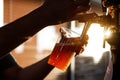 Pouring beer into a plastic glass. Sunset Royalty Free Stock Photo