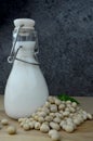 Pouring bio soy milk on rustic wood dark background Royalty Free Stock Photo