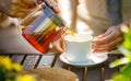 Pouring black tea into glass cup Royalty Free Stock Photo