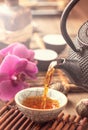 Pouring black tea vertical closeup