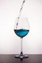 Pouring blue liquid to wine glass Royalty Free Stock Photo