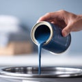 Pouring blue paint, fresh start, creative process. DIY renovation concept. Use for artistic projects, home improvement, Royalty Free Stock Photo