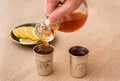 Pouring brandy into the silver drinking vessels