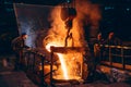 Pouring bright liquid iron or metal with sparks into container in steel mill or workshop blast furnace foundry. Metal Royalty Free Stock Photo