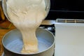 Pouring cake dough into a baking pan Royalty Free Stock Photo