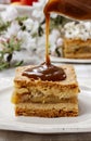 Pouring caramel sauce on piece of apple pie