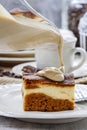 Pouring caramel sauce on piece of cake