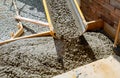 Pouring cement during paving concrete pavement near the house Royalty Free Stock Photo